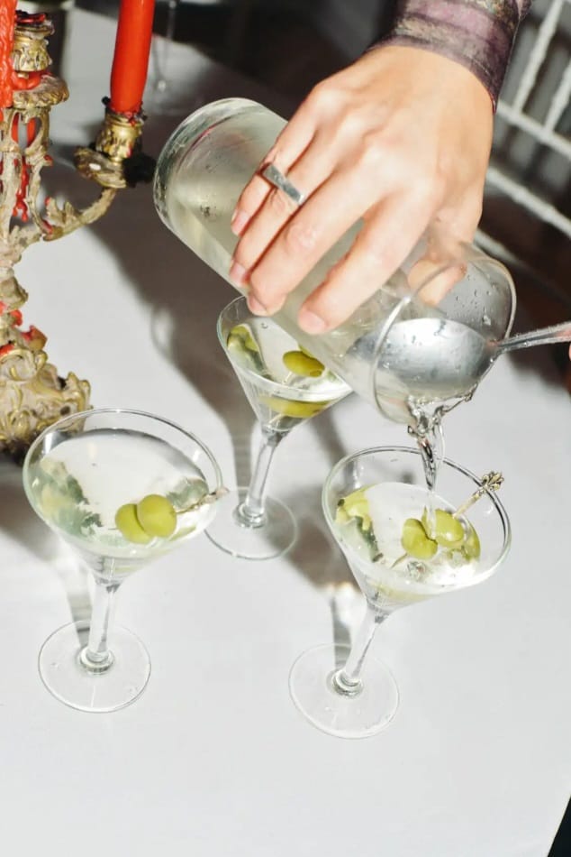 An elegant pour of wine at a candlelit table